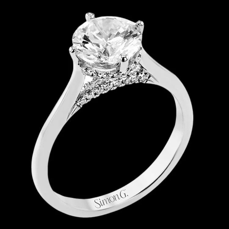 Women’s pear-shaped engagement rings-This elegant white gold engagement ring takes a round center and is adorned with a delicate under halo, and a line of diamonds on the side profile 0.13 ctw