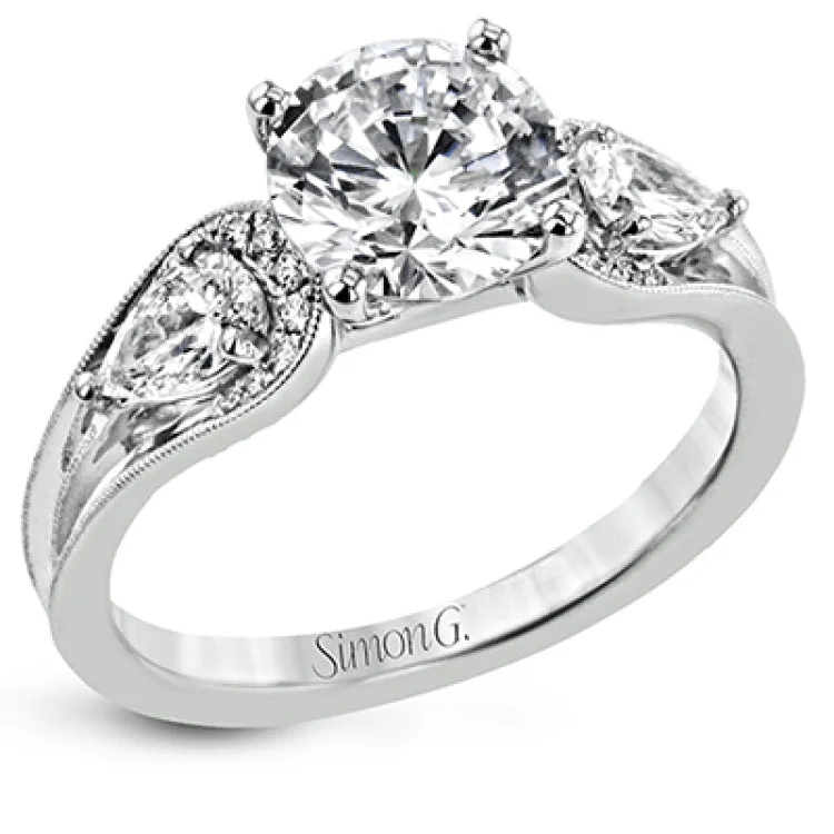 Women’s custom engagement rings-This modern 3 stone engagement ring takes a Round center and is flanked by 2 pear shaped diamonds 0.36 ctw., and 0.06 ctw of round diamonds