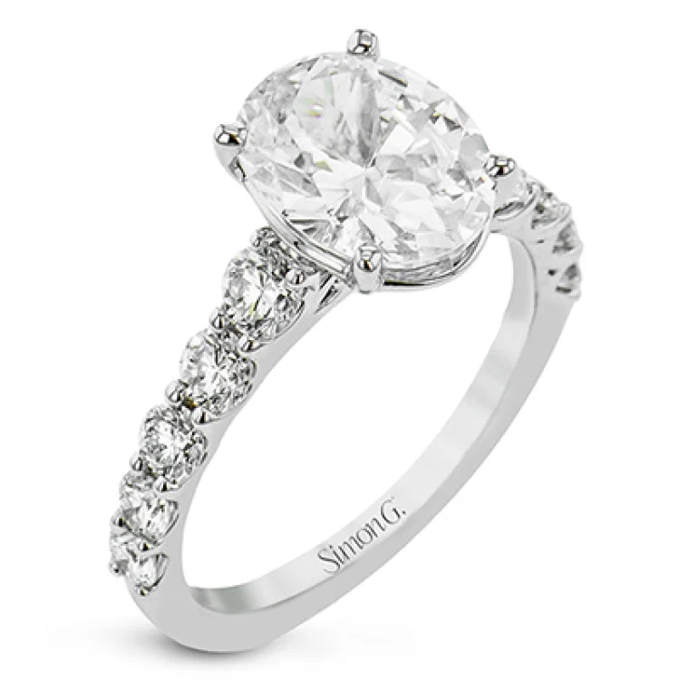 Women’s custom diamond engagement rings-This elegant 18 kt white gold engagement ring has graduated diamonds trailing down the sides totaling 1.14 ctw., and takes an oval center