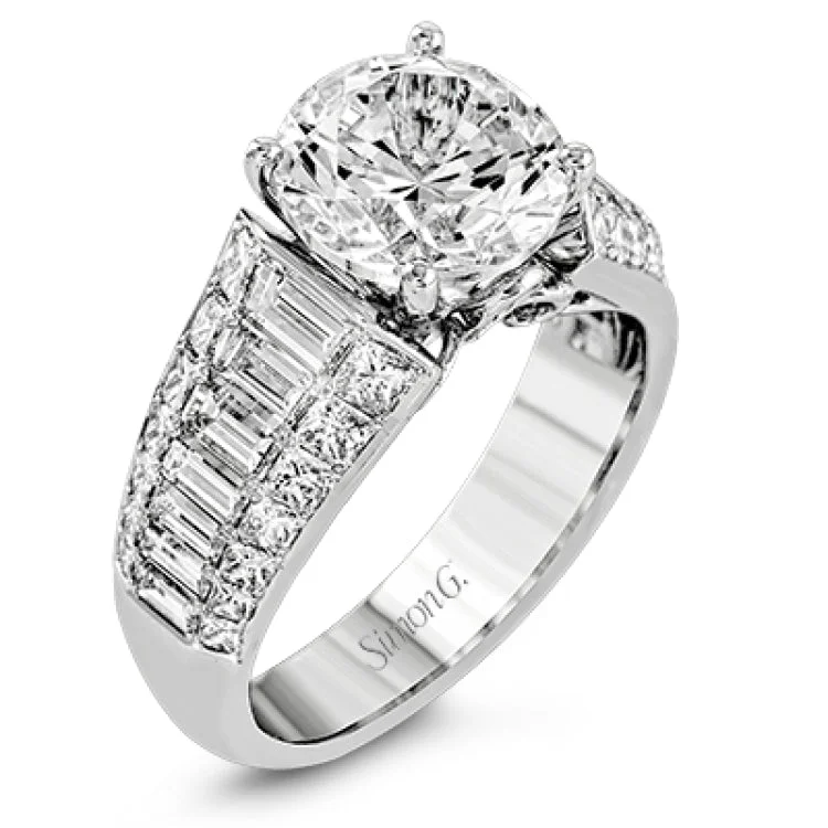 Women’s pear-shaped engagement rings-This significant engagement ring is sure to make a statement with 1.13 baguette diamond side stones outlined my .98 ctw of princess cut diamonds.