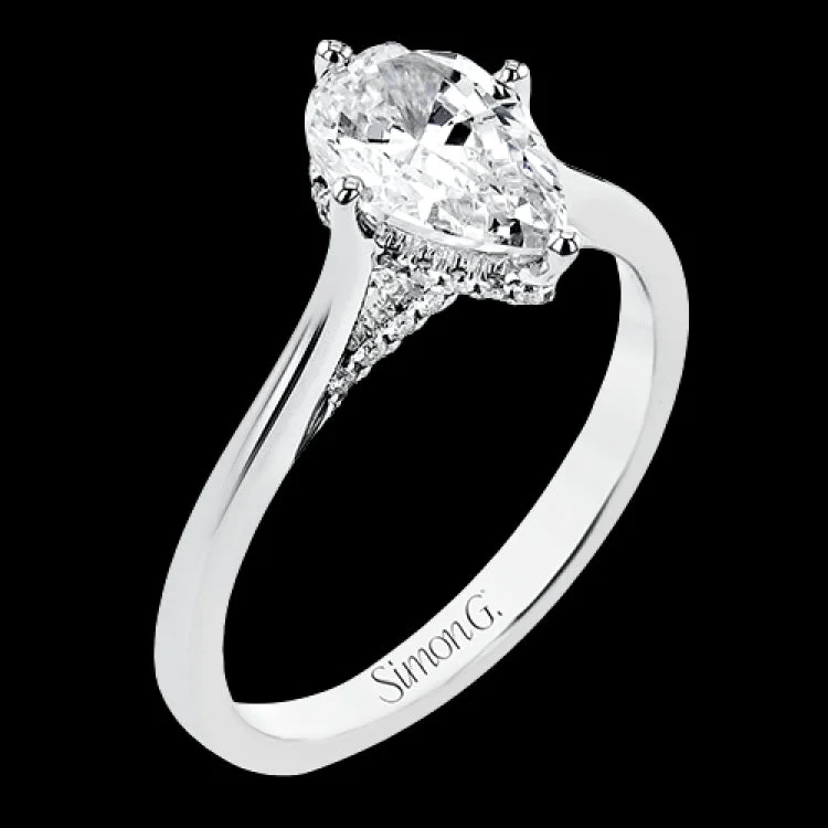 Women’s cushion cut engagement rings-This elegant white gold engagement ring takes a pear shape center and is adorned with a delicate under halo, and a line of diamonds on the side profile 0.13 ctw