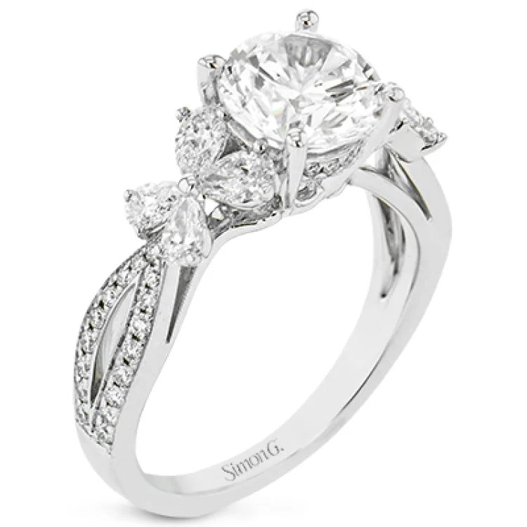 Women’s platinum diamond engagement rings-A beautiful engagement ring perfect for those who love floral inspired designs. It features a split shank setting with diamond accents .20ctw., & 8 pear shaped diamonds .62ctw. that create the look of petals around the center stone.